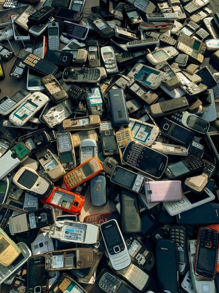 pexels-photo-19037726-19037726 A collection of old and obsolete mobile phones stacked for recycling purposes.
